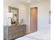 Bedroom with a large mirror, dresser with decor, and doorway leading to another room at 5911 Wetlands Aly, Charlotte, NC 28215