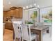 Dining area with wood table, upholstered chairs, modern lighting, and decorative art at 5911 Wetlands Aly, Charlotte, NC 28215