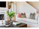 Bright living room with a cozy sofa, modern fireplace, decorative mirror, and natural light at 5911 Wetlands Aly, Charlotte, NC 28215