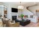 Cozy living room with fireplace, comfortable seating, stylish decor, and a large mirror accent at 5911 Wetlands Aly, Charlotte, NC 28215