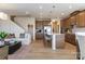 Open-concept living area featuring hardwood floors, stainless appliances, an island, and a cozy seating area at 5911 Wetlands Aly, Charlotte, NC 28215