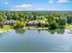 Expansive lakefront estate with lush greenery providing privacy and scenic views, perfect for luxurious living at 6823 Manatee Dr, Concord, NC 28025