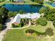 A captivating aerial view of a brick home featuring a lush landscaped yard and a serene lake backdrop at 6823 Manatee Dr, Concord, NC 28025