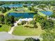 Aerial view of a home on the water with lush landscaping and a well-maintained lawn at 6823 Manatee Dr, Concord, NC 28025