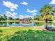 Picturesque backyard with a lake, dock, lawn, palm tree, hammock and beautiful skies at 6823 Manatee Dr, Concord, NC 28025