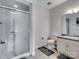 Bright bathroom featuring a glass-enclosed shower, toilet, and vanity with ample lighting at 6823 Manatee Dr, Concord, NC 28025