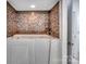 Relaxing bathroom featuring a tiled walk-in tub with massage jets and sleek faucet fixtures at 6823 Manatee Dr, Concord, NC 28025