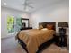 Comfortable bedroom with a ceiling fan, natural light, and dark wood furniture at 6823 Manatee Dr, Concord, NC 28025