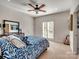 Cozy bedroom with a white brick wall, ceiling fan, and bright window at 6823 Manatee Dr, Concord, NC 28025