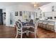 Breakfast nook with hardwood floors, a chandelier, and a view of the kitchen at 6823 Manatee Dr, Concord, NC 28025