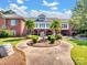 Beautiful exterior view of a large brick building with well-maintained grounds, fountain and circular driveway at 6823 Manatee Dr, Concord, NC 28025