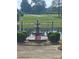 Three-tiered fountain on a circular platform by a pond with a security sign at 6823 Manatee Dr, Concord, NC 28025
