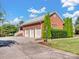 Large brick garage with three bays and a long driveway at 6823 Manatee Dr, Concord, NC 28025