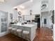 Spacious kitchen with white cabinets, a large island, and seating for four at 6823 Manatee Dr, Concord, NC 28025