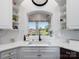 Bright kitchen with white cabinets and countertops, featuring a view of the lake at 6823 Manatee Dr, Concord, NC 28025
