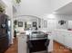 Bright kitchen with stainless steel appliances, hardwood floors, and white cabinets at 6823 Manatee Dr, Concord, NC 28025