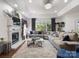 Bright living room with fireplace, plush sofa, and large windows at 6823 Manatee Dr, Concord, NC 28025