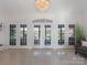 Bright living room with high ceilings, marble floors and French doors offering scenic views and plenty of natural light at 6823 Manatee Dr, Concord, NC 28025