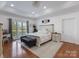 Serene main bedroom with tray ceilings, natural light, and a decorative rug under a stylish bed at 6823 Manatee Dr, Concord, NC 28025