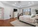 Bright bedroom featuring wood floors, neutral walls, and a view to the outside at 6823 Manatee Dr, Concord, NC 28025