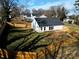 Aerial view of a fenced in backyard with green grass, shade, and recently installed roof at 713 E Third Ave, Gastonia, NC 28054
