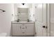 Bathroom featuring dual sinks, granite countertops, and modern fixtures at 713 E Third Ave, Gastonia, NC 28054