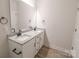 Bathroom featuring dual sinks, granite countertops, modern fixtures, and ample storage space at 713 E Third Ave, Gastonia, NC 28054
