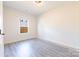 Clean bedroom featuring hard-surface floors and a window overlooking a wood fence at 713 E Third Ave, Gastonia, NC 28054