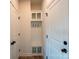 Hallway featuring a built-in coat rack with seating, cabinet storage, and modern fixtures at 713 E Third Ave, Gastonia, NC 28054
