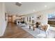 Bright open concept living room with wood floors flowing into the kitchen with a dining area and large windows at 713 E Third Ave, Gastonia, NC 28054