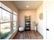 Bright sitting room featuring wood-look floors, large windows, ladder shelf, and decorative artwork at 713 E Third Ave, Gastonia, NC 28054