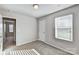 Bedroom with neutral walls and carpet features a window and closet at 8023 Downy Oak Ln, Charlotte, NC 28269