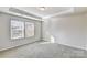 Bedroom with neutral walls and carpet features two windows for natural light at 8023 Downy Oak Ln, Charlotte, NC 28269