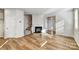 Open-concept living room featuring hardwood floors, fireplace, staircase and ample natural light at 8023 Downy Oak Ln, Charlotte, NC 28269