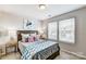 Well-lit bedroom featuring plush carpet, decor and bright double windows at 8027 Downy Oak Ln, Charlotte, NC 28269
