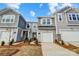 Charming townhome featuring gray siding, a one-car garage, and tasteful landscaping at 8027 Downy Oak Ln, Charlotte, NC 28269