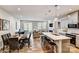 Open-concept kitchen with a large island, stainless steel appliances, and adjacent dining and living areas at 8027 Downy Oak Ln, Charlotte, NC 28269