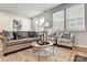 Bright and airy living room featuring neutral tones, stylish seating, and access to an outdoor space at 8027 Downy Oak Ln, Charlotte, NC 28269