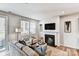 Cozy living room with a fireplace, comfortable seating, and natural light from a sliding glass door at 8027 Downy Oak Ln, Charlotte, NC 28269