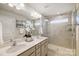 Bright bathroom with a double sink vanity and glass enclosed shower at 8031 Downy Oak Ln, Charlotte, NC 28269