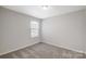 Bedroom with neutral carpet and a window for natural light at 8031 Downy Oak Ln, Charlotte, NC 28269
