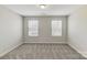 Bedroom featuring neutral carpet and two windows for natural light at 8031 Downy Oak Ln, Charlotte, NC 28269