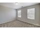 Bedroom featuring neutral carpet and two windows for natural light at 8031 Downy Oak Ln, Charlotte, NC 28269