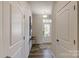 Bright entryway featuring wood floors, white walls, and a glass-paneled front door at 8031 Downy Oak Ln, Charlotte, NC 28269