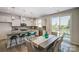 Open concept kitchen and dining area with pendant lighting, stainless steel appliances, and backyard access at 8031 Downy Oak Ln, Charlotte, NC 28269