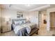 Well-appointed main bedroom with a sitting area, ample natural light, and relaxing color palette at 8031 Downy Oak Ln, Charlotte, NC 28269