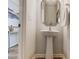Well-lit powder room with modern fixtures, decorative mirror, and pedestal sink at 8031 Downy Oak Ln, Charlotte, NC 28269