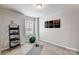 Bright exercise room with gray walls, a large window, carpeted floors, and basic workout equipment at 8035 Downy Oak Ln, Charlotte, NC 28269