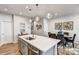 Open kitchen features stainless steel appliances, a central island, and pendant lighting at 8035 Downy Oak Ln, Charlotte, NC 28269
