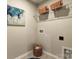 Functional laundry area with shelving, storage baskets, and a neutral color scheme at 8035 Downy Oak Ln, Charlotte, NC 28269